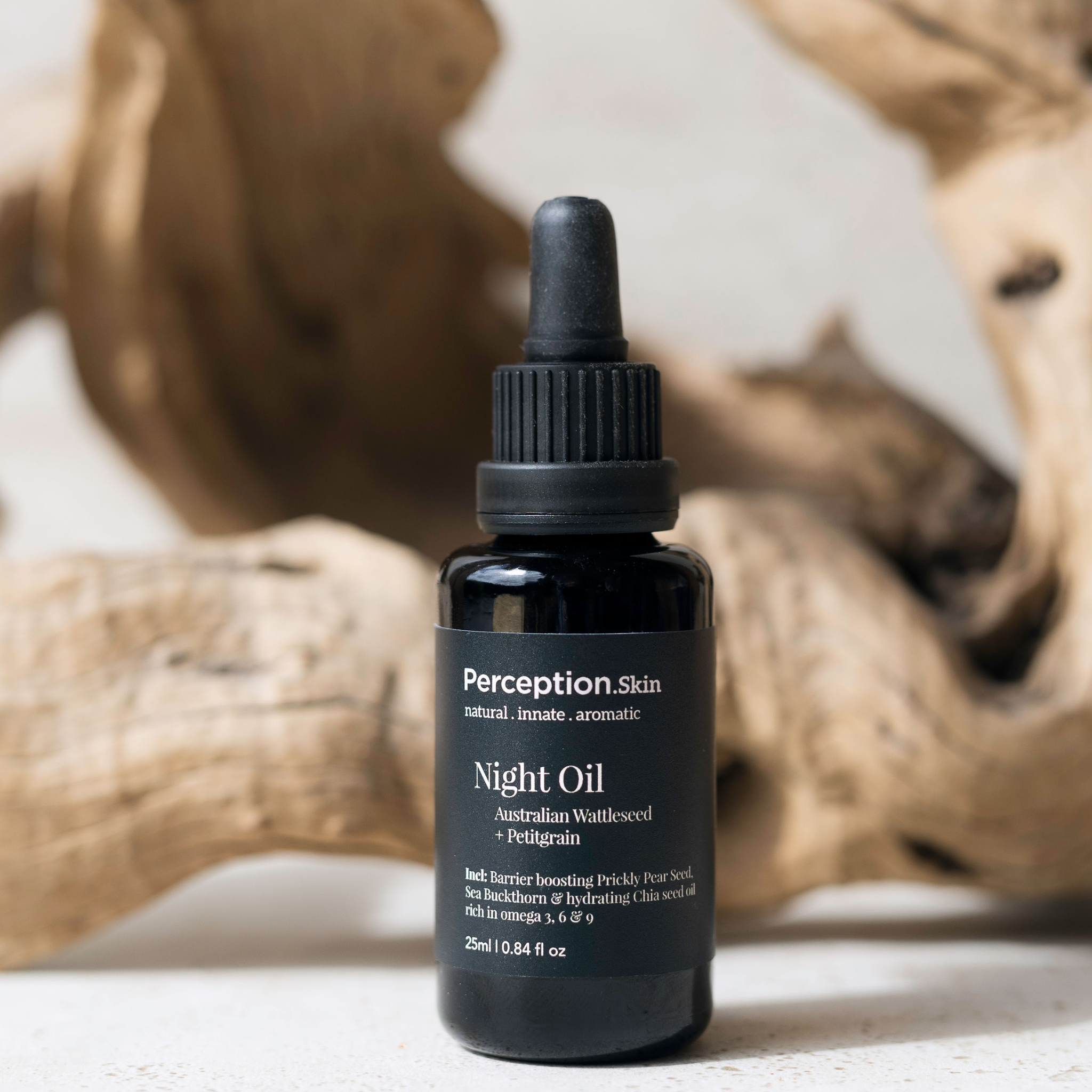 Perception Skin Night Oil bottle with a dropper on a neutral background