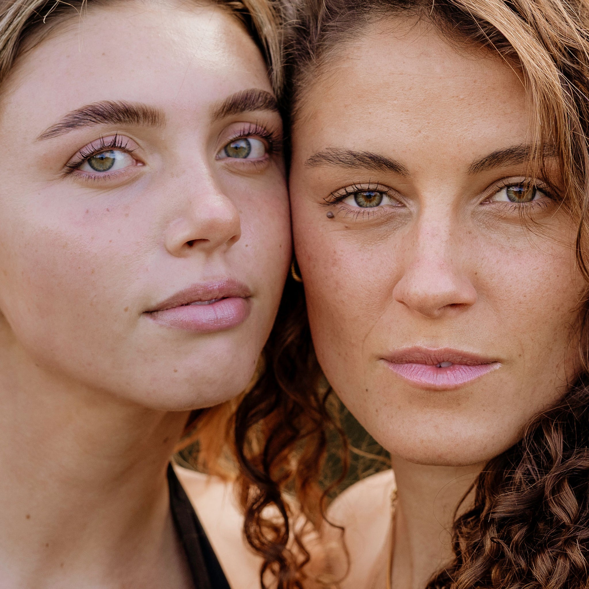 Close-up of two women with a neutral background