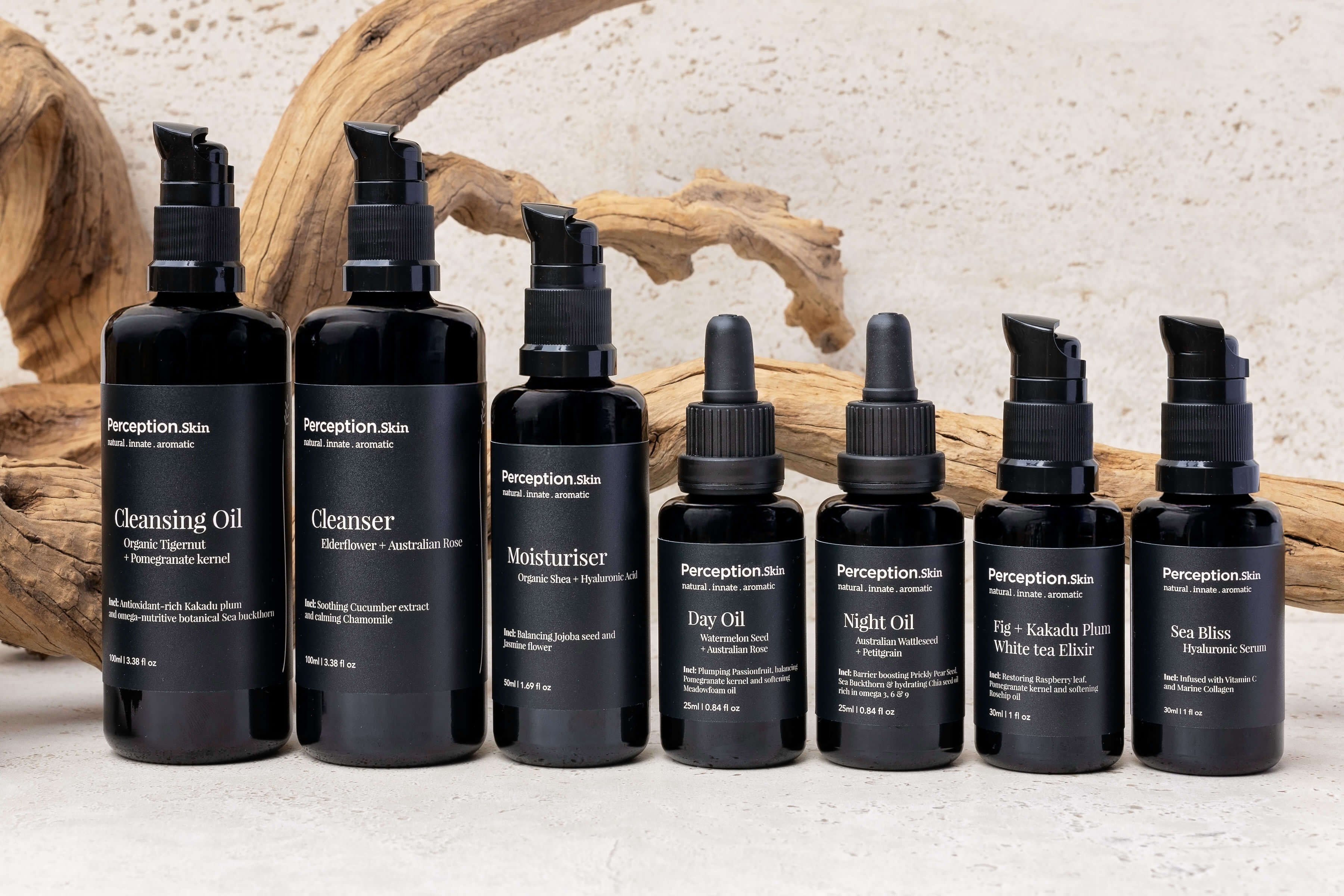 Set of black Perception Skin skincare bottles with labels on a textured surface with wooden elements.