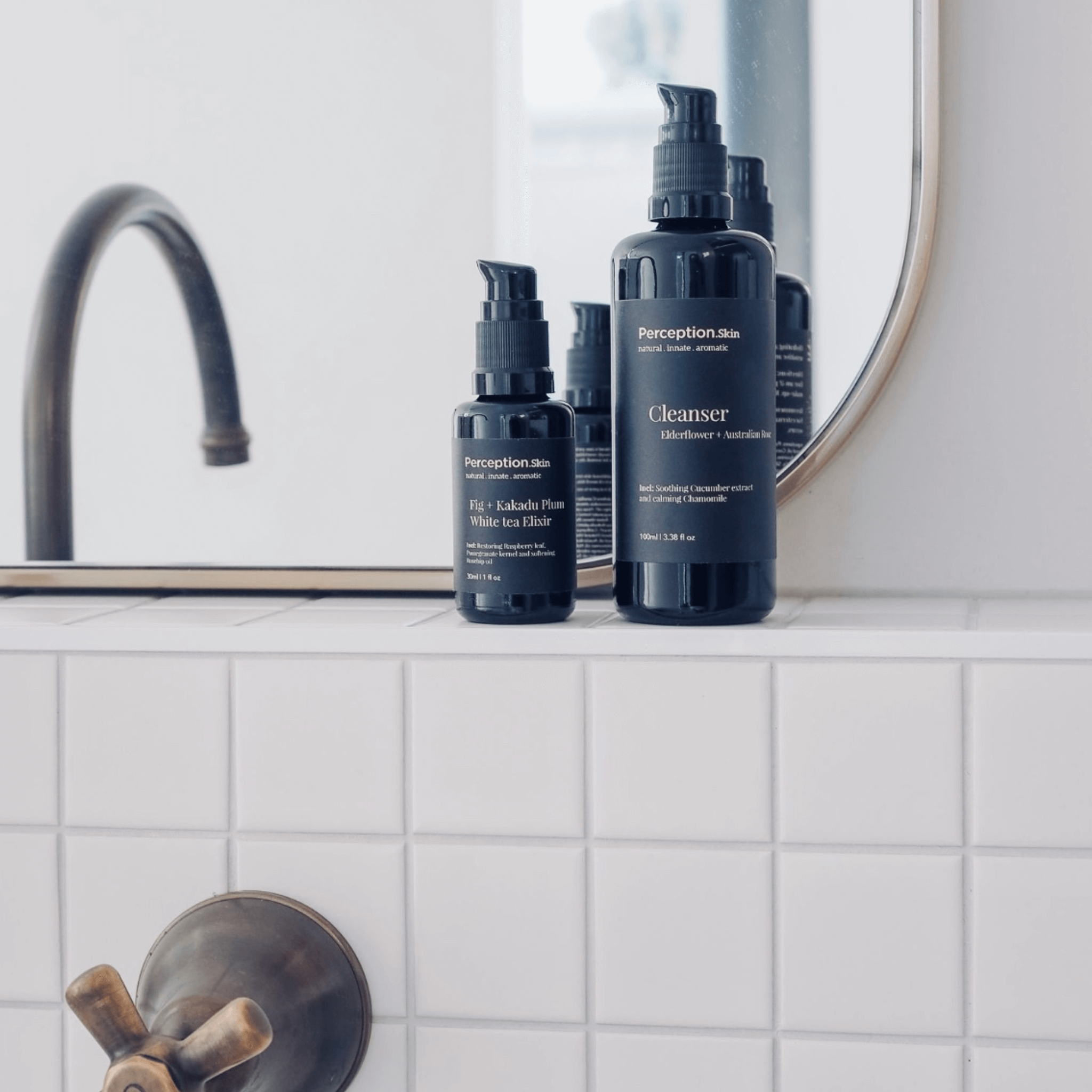 Bathroom setting with Perception Skincare bottles on a tiled shelf.