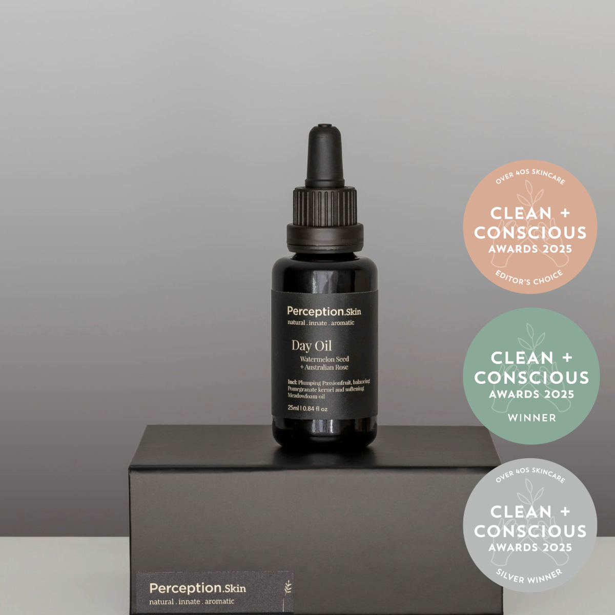 Black bottle with dropper labeled 'Perception Skin' on a gray platform, with Clean + Conscious awards badges in the background.