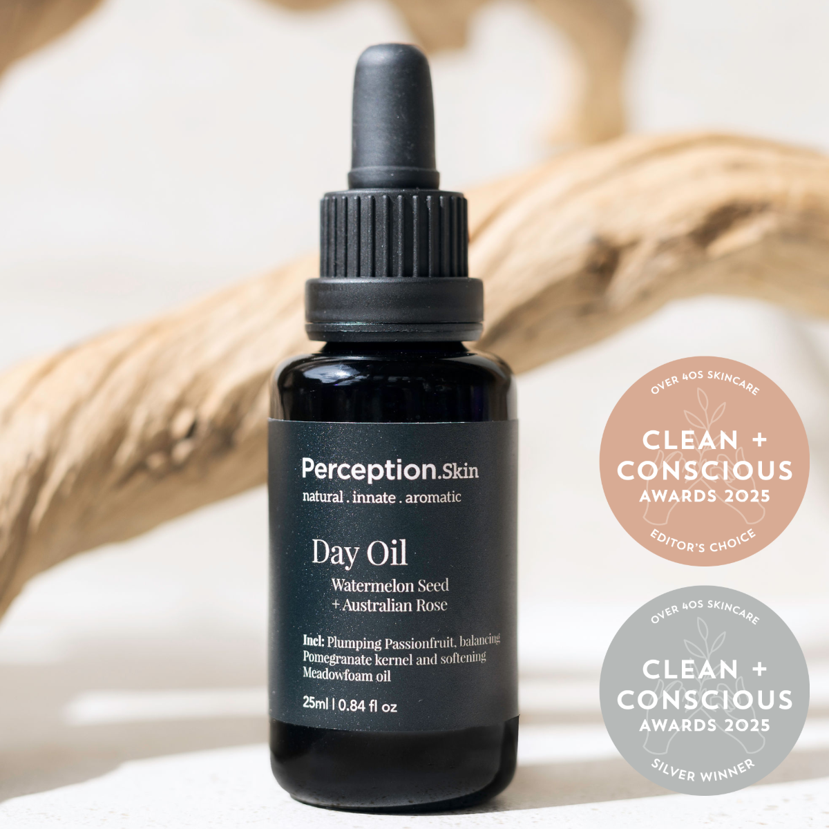 Perception Skin Day Oil bottle with awards on a neutral background