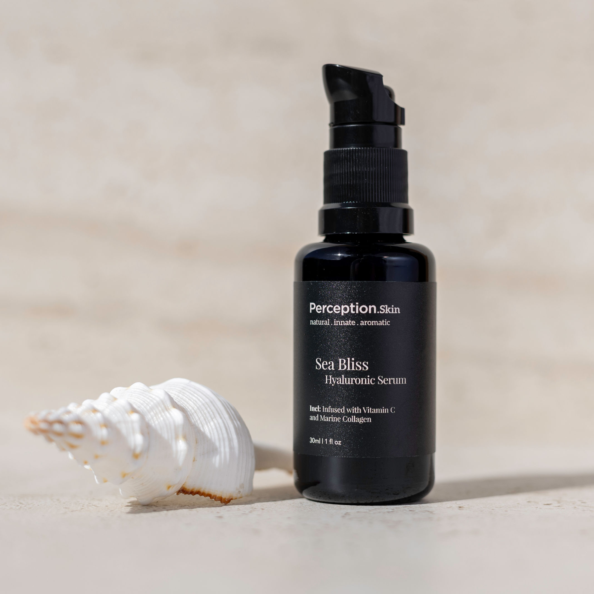 Black serum bottle labeled 'Perception Skin' with a shell on a beige background