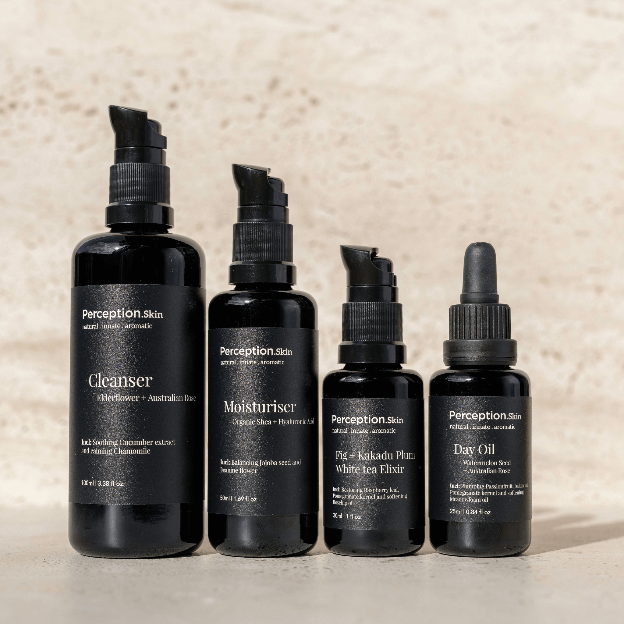 Set of black Perception Skincare bundle bottles with labels on a beige background