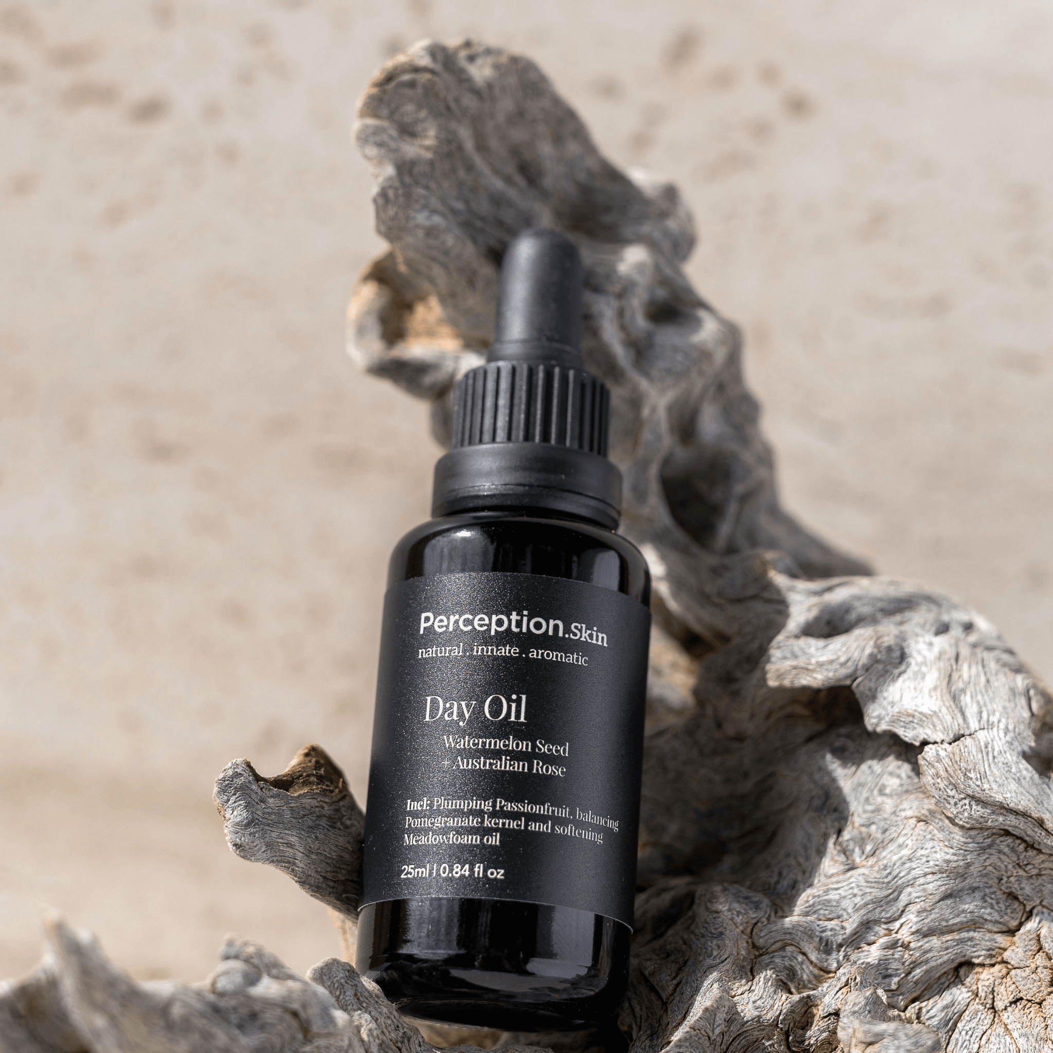 Black bottle of Perception Skin Day Oil on a natural wooden surface