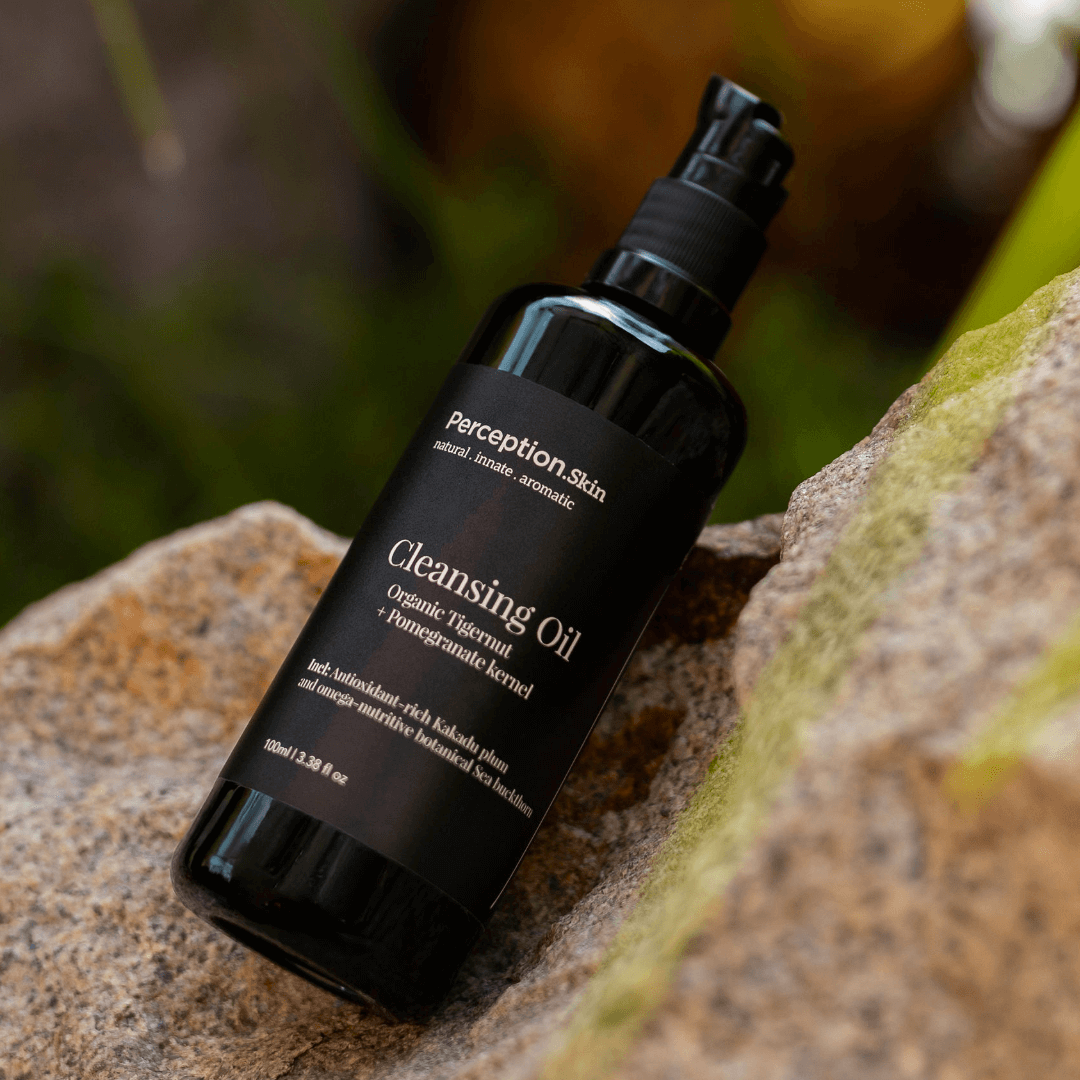 Perception Skin Cleansing Oil bottle on a stone surface with natural background