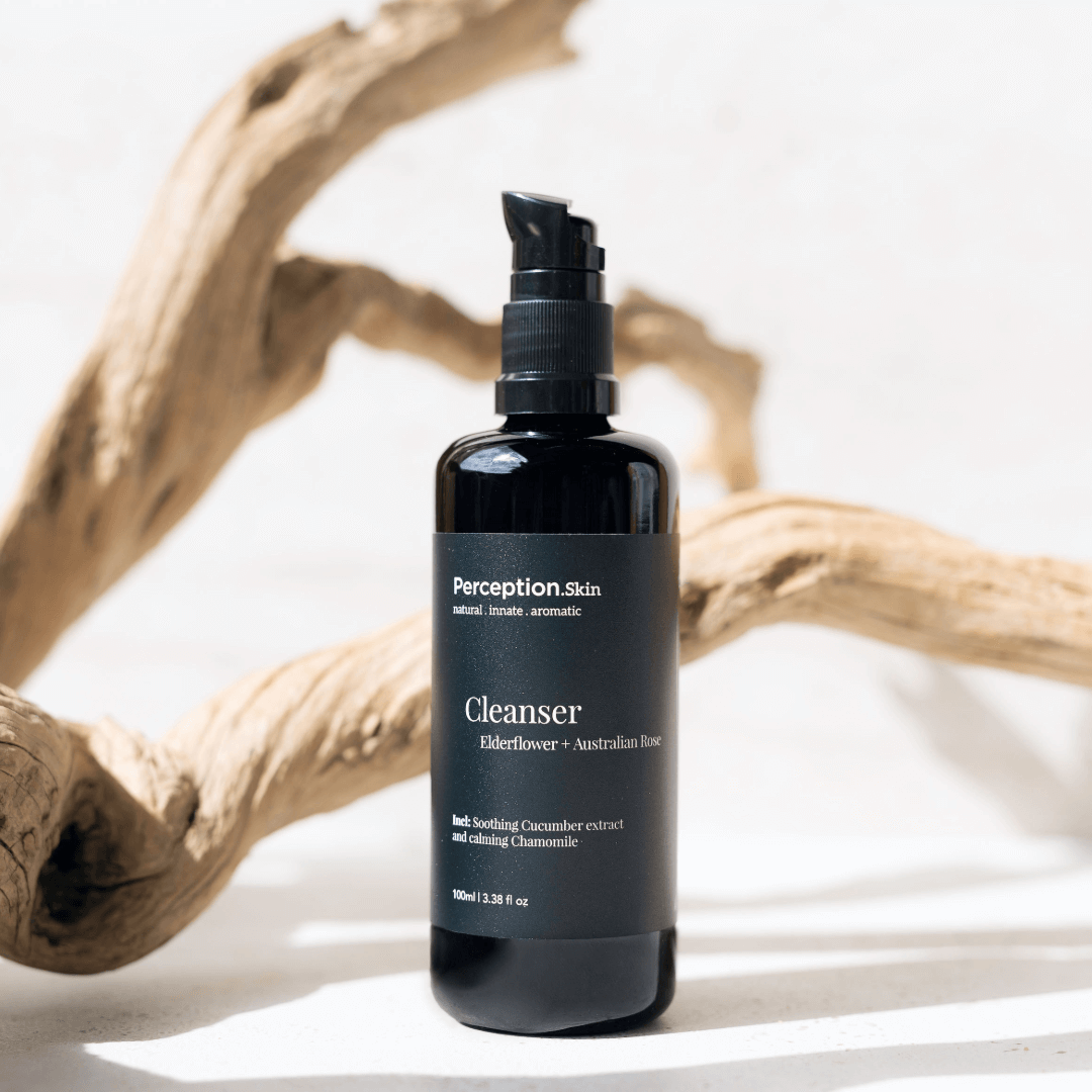 Perception Skin Cleanser bottle on a light background with natural elements